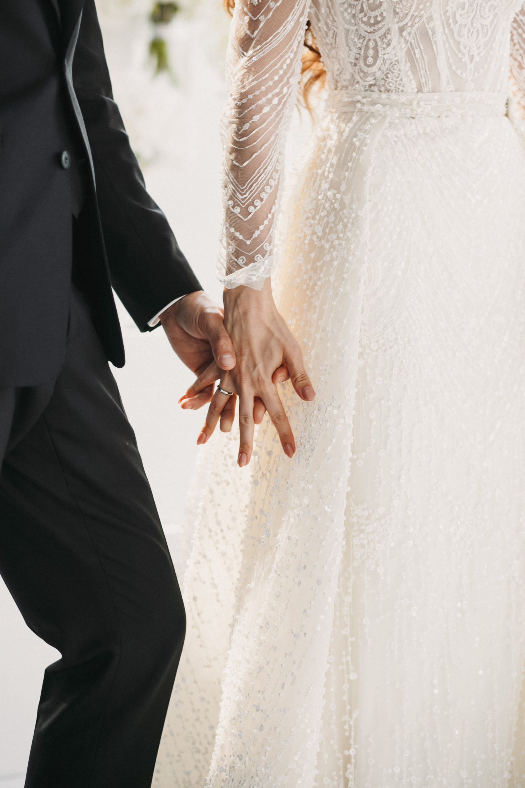 Close up the wedding couple hold hands